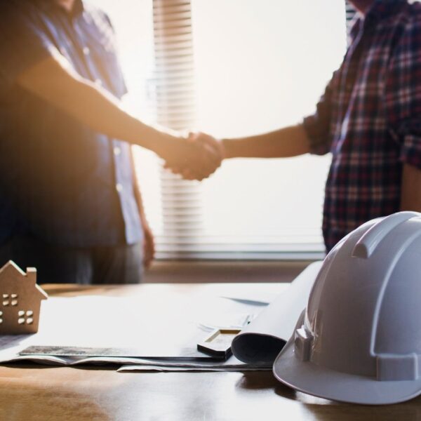 handshake over insurance paperwork