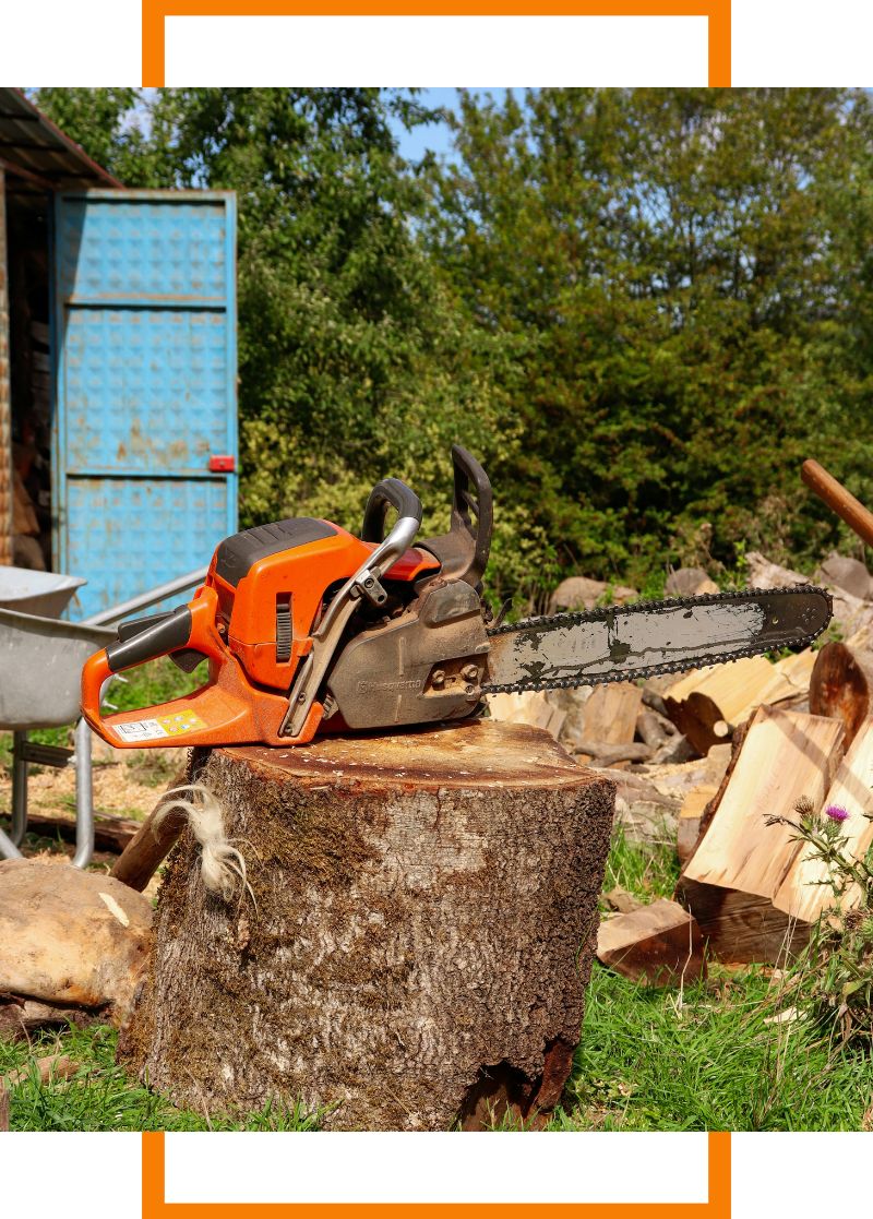 a chainsaw sitting on a stump